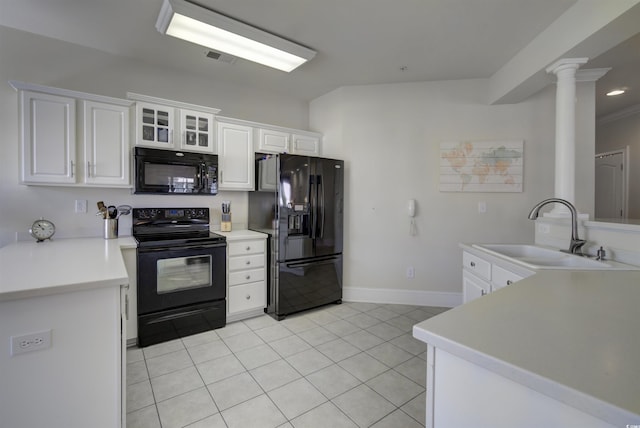 2180 Waterview Dr Unit 738, North Myrtle Beach, SC 29582 - kitchen with black appliances, light tile patterned flooring, white cabinetry, light countertops, and ornate columns