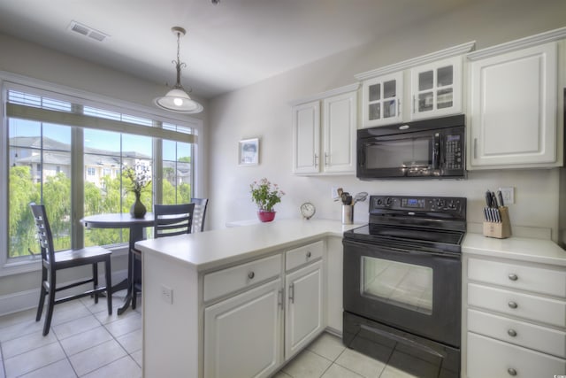 2180 Waterview Dr Unit 738, North Myrtle Beach, SC 29582 - kitchen with black appliances, light tile patterned floors, a peninsula, white cabinets, and light countertops