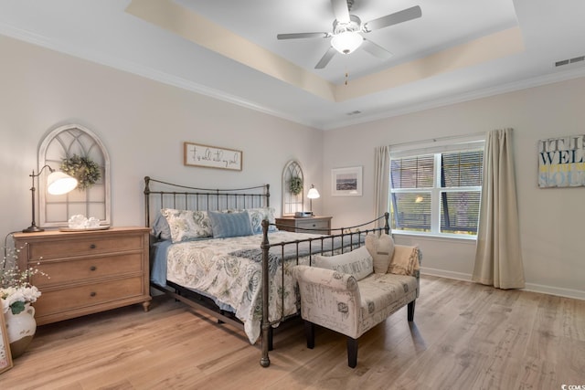 3185 Viceroy Loop, Little River, SC 29566 - bedroom featuring a tray ceiling, light wood finished floors, ornamental molding, and a ceiling fan