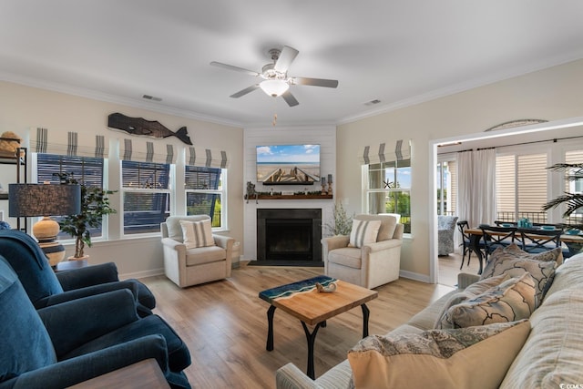 3185 Viceroy Loop, Little River, SC 29566 - living room with a fireplace with flush hearth, a ceiling fan, crown molding, and light wood finished floors