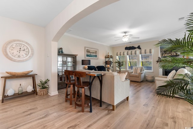 3185 Viceroy Loop, Little River, SC 29566 - living area featuring arched walkways, ceiling fan, light wood-style floors, and ornamental molding