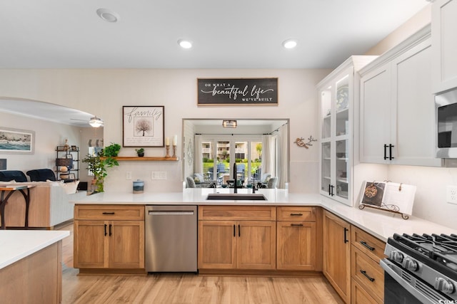 3185 Viceroy Loop, Little River, SC 29566 - kitchen featuring stainless steel appliances, light countertops, light wood-type flooring, glass insert cabinets, and white cabinets