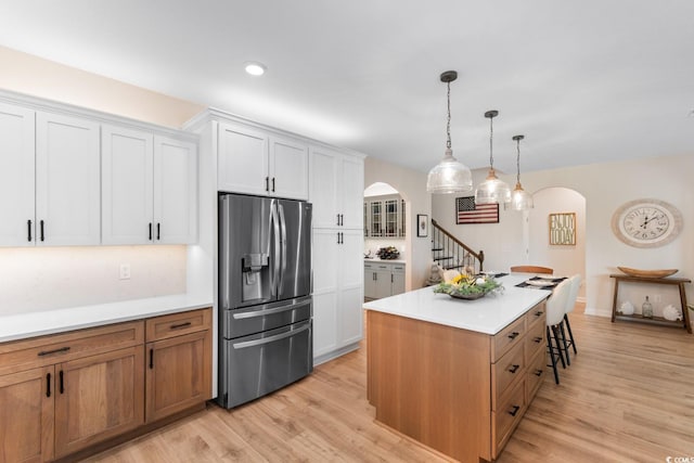 3185 Viceroy Loop, Little River, SC 29566 - kitchen featuring stainless steel fridge with ice dispenser, arched walkways, light wood-style floors, and recessed lighting