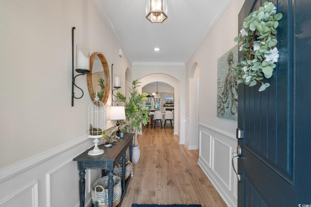 3185 Viceroy Loop, Little River, SC 29566 - entrance foyer with arched walkways, ornamental molding, wainscoting, light wood-style floors, and a decorative wall