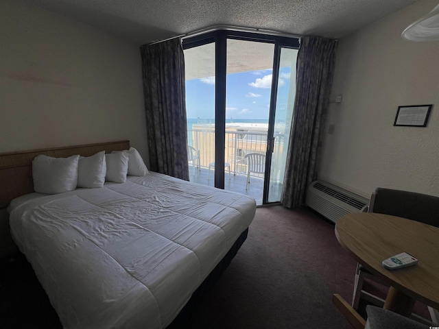 9550 Shore Dr Unit 1733, Myrtle Beach, SC 29579 - carpeted bedroom with access to exterior, a textured ceiling, a wall of windows, a water view, and a wall unit AC