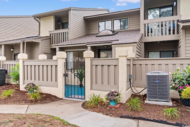 620 15th Ave S Unit 87, Surfside Beach, SC 29575 - view of front facade with a balcony, a gate, a fenced front yard, and roof with shingles