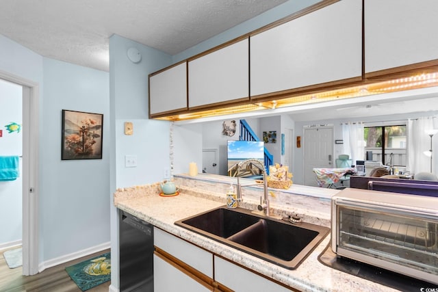620 15th Ave S Unit 87, Surfside Beach, SC 29575 - kitchen featuring black dishwasher, wood finished floors, white cabinetry, open floor plan, and a textured ceiling