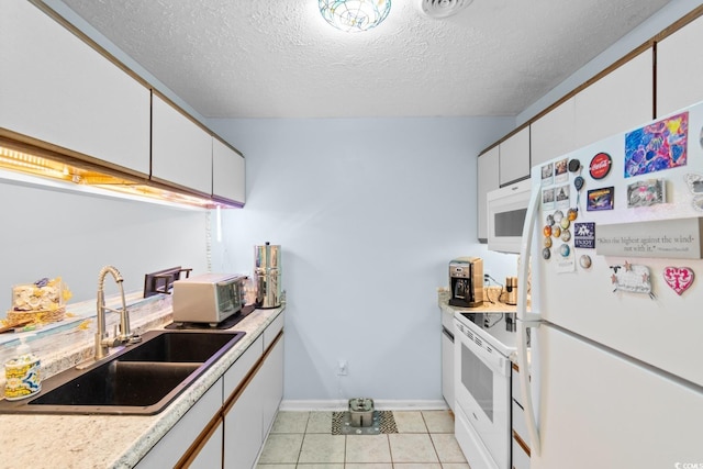 620 15th Ave S Unit 87, Surfside Beach, SC 29575 - kitchen with white appliances, light countertops, a textured ceiling, white cabinets, and light tile patterned floors