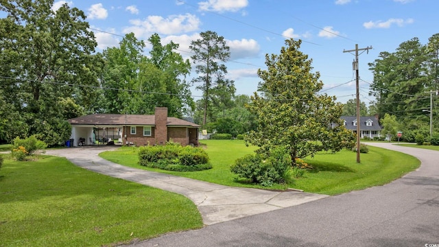 300 Crescent Dr, Conway, SC 29526 - view of front of home with a chimney, a front yard, driveway, a carport, and brick siding