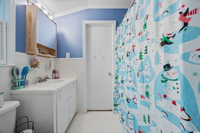300 Crescent Dr, Conway, SC 29526 - full bathroom with vanity, tile walls, crown molding, a textured ceiling, and tile patterned floors