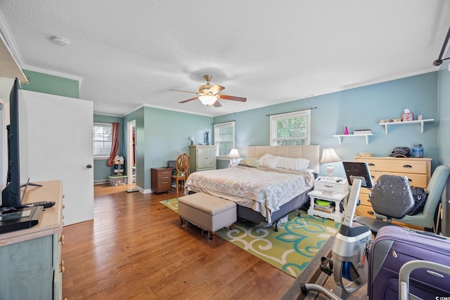 300 Crescent Dr, Conway, SC 29526 - bedroom featuring ornamental molding, multiple windows, wood finished floors, a textured ceiling, and a ceiling fan