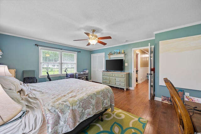 300 Crescent Dr, Conway, SC 29526 - bedroom with wood finished floors, a closet, a textured ceiling, crown molding, and a ceiling fan