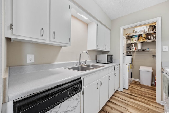 615 Carter Ln Unit D6, Conway, SC 29526 - kitchen with stainless steel microwave, white dishwasher, white cabinetry, light countertops, and light wood-style flooring