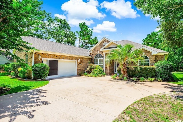 4499 Firethorne Dr, Murrells Inlet, SC 29576 - ranch-style house with brick siding, a garage, driveway, roof with shingles, and a front lawn