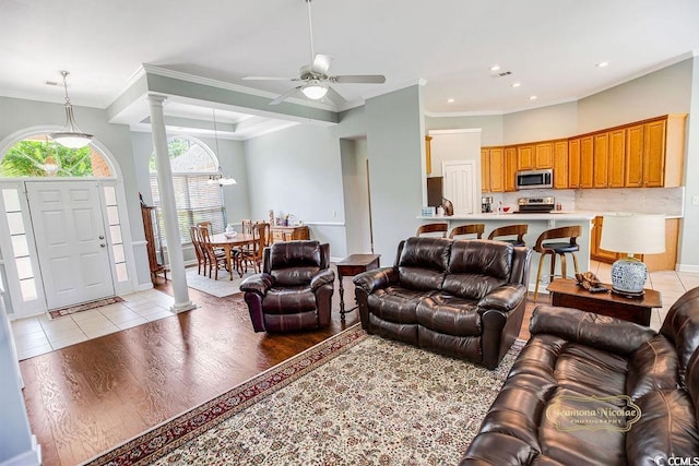 4499 Firethorne Dr, Murrells Inlet, SC 29576 - living room featuring ornate columns, crown molding, ceiling fan, light wood-style flooring, and recessed lighting