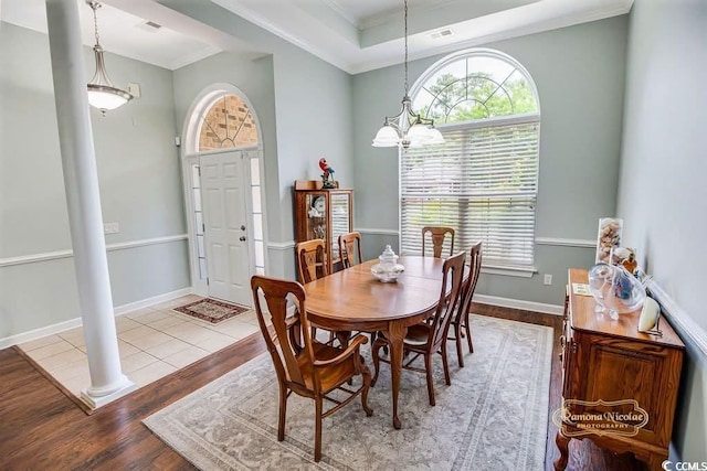 4499 Firethorne Dr, Murrells Inlet, SC 29576 - dining space featuring wood finished floors, healthy amount of natural light, ornate columns, a chandelier, and ornamental molding