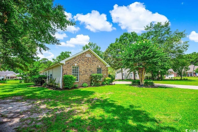 4499 Firethorne Dr, Murrells Inlet, SC 29576 - view of side of property with brick siding and a yard