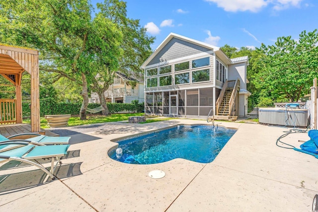 3597 Sunfish St, Murrells Inlet, SC 29576 - swimming pool featuring a sunroom, a patio area, stairs, and a covered hot tub