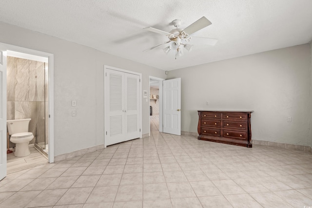 3597 Sunfish St, Murrells Inlet, SC 29576 - unfurnished bedroom with a closet, a textured ceiling, ceiling fan, and ensuite bathroom