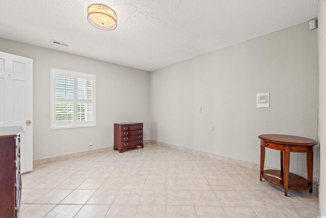 3597 Sunfish St, Murrells Inlet, SC 29576 - empty room with a textured ceiling and light tile patterned flooring