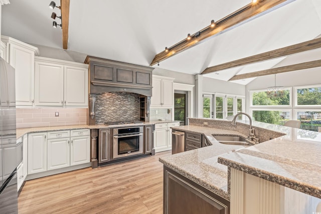 3597 Sunfish St, Murrells Inlet, SC 29576 - kitchen with appliances with stainless steel finishes, beam ceiling, backsplash, light wood finished floors, and custom exhaust hood