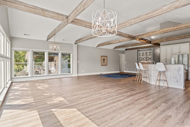 3597 Sunfish St, Murrells Inlet, SC 29576 - unfurnished living room with a chandelier, beamed ceiling, and light wood-style flooring