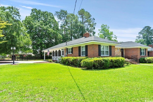 1008 N Withlacoochee Ave, Marion, SC 29571 - view of front of property featuring a chimney, brick siding, driveway, and a carport