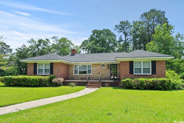 1008 N Withlacoochee Ave, Marion, SC 29571 - single story home featuring a front lawn, a chimney, brick siding, and covered porch