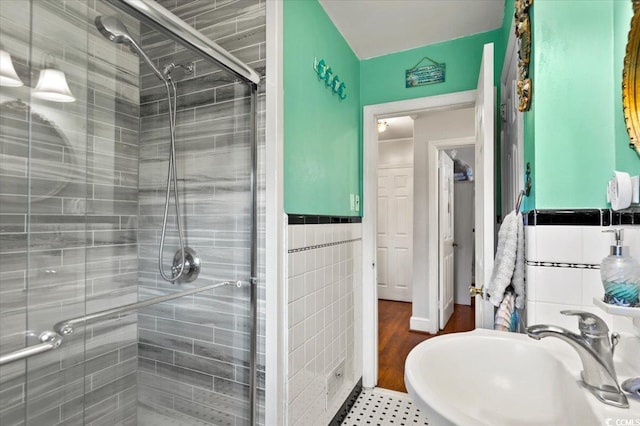 1008 N Withlacoochee Ave, Marion, SC 29571 - full bathroom featuring a stall shower, tile walls, and a wainscoted wall