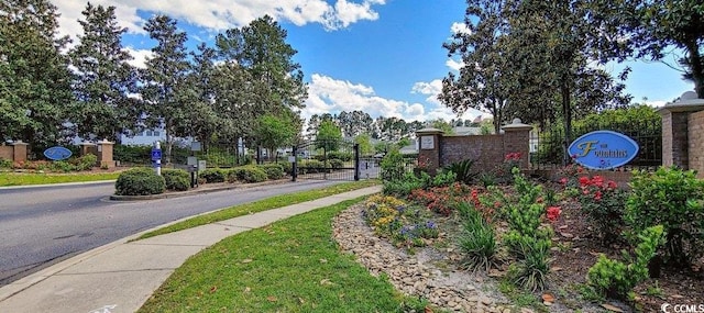 5046 Belleglen Ct Unit 202, Myrtle Beach, SC 29579 - view of asphalt road with sidewalks, a gate, curbs, and a gated entry