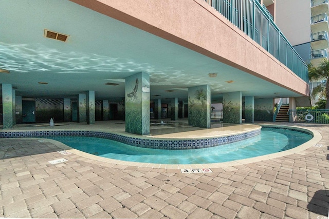 2207 S Ocean Blvd Unit 718, Myrtle Beach, SC 29577 - indoor pool featuring stairs and a patio area