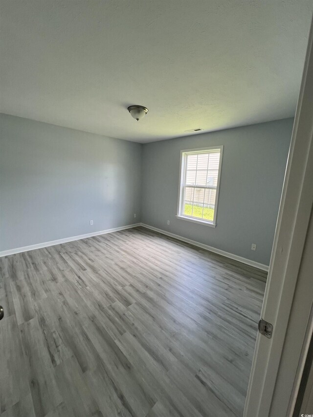 9888 Conifer Ln, Murrells Inlet, SC 29576 - unfurnished room with wood finished floors and baseboards