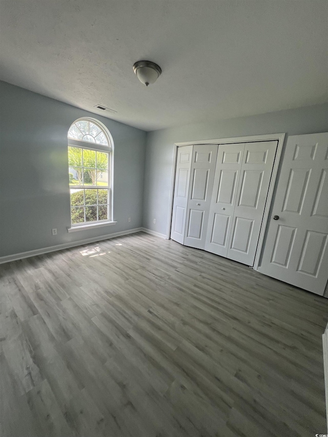 9888 Conifer Ln, Murrells Inlet, SC 29576 - unfurnished bedroom featuring wood finished floors and a closet