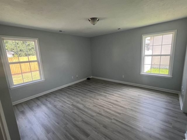 9888 Conifer Ln, Murrells Inlet, SC 29576 - empty room with healthy amount of natural light and dark wood-style floors