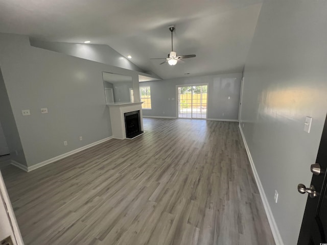 9888 Conifer Ln, Murrells Inlet, SC 29576 - unfurnished living room featuring a fireplace, ceiling fan, wood finished floors, and vaulted ceiling