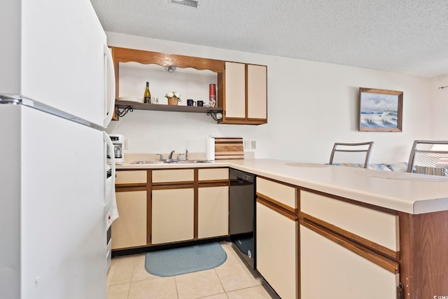 500 Fairway Village Dr Unit J-7, Myrtle Beach, SC 29588 - kitchen featuring freestanding refrigerator, black dishwasher, a peninsula, light tile patterned floors, and a textured ceiling