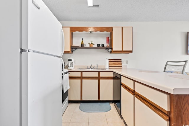 500 Fairway Village Dr Unit J-7, Myrtle Beach, SC 29588 - kitchen with freestanding refrigerator, a peninsula, black dishwasher, open shelves, and light tile patterned flooring