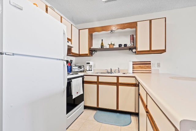 500 Fairway Village Dr Unit J-7, Myrtle Beach, SC 29588 - kitchen featuring freestanding refrigerator, electric stove, light countertops, under cabinet range hood, and light tile patterned flooring