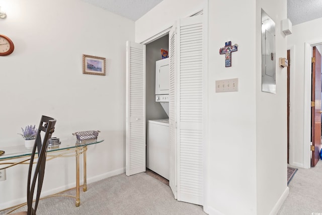 500 Fairway Village Dr Unit J-7, Myrtle Beach, SC 29588 - washroom with stacked washing machine and dryer, light colored carpet, electric panel, and a textured ceiling