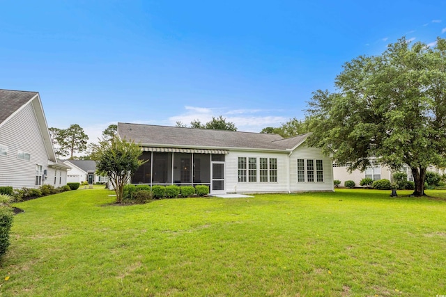 583 Wildflower Trl, Myrtle Beach, SC 29579 - back of property featuring a sunroom, a lawn, and roof with shingles