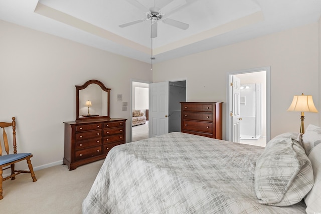 583 Wildflower Trl, Myrtle Beach, SC 29579 - bedroom featuring light carpet, a tray ceiling, ensuite bathroom, and a spacious closet
