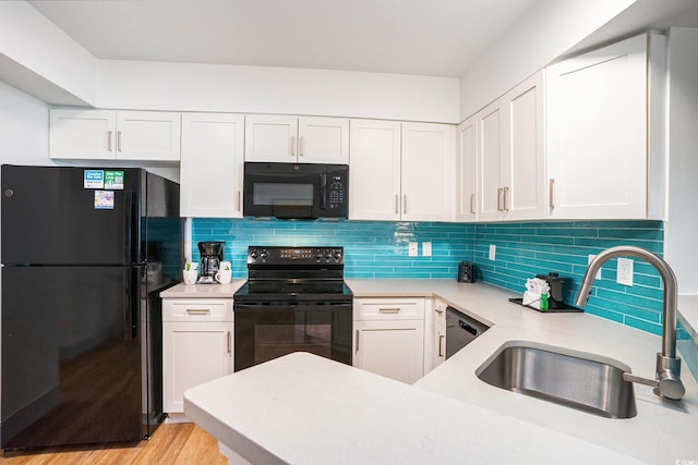 3000 N Ocean Blvd Unit 209, Myrtle Beach, SC 29577 - kitchen featuring black appliances, light countertops, white cabinets, and decorative backsplash