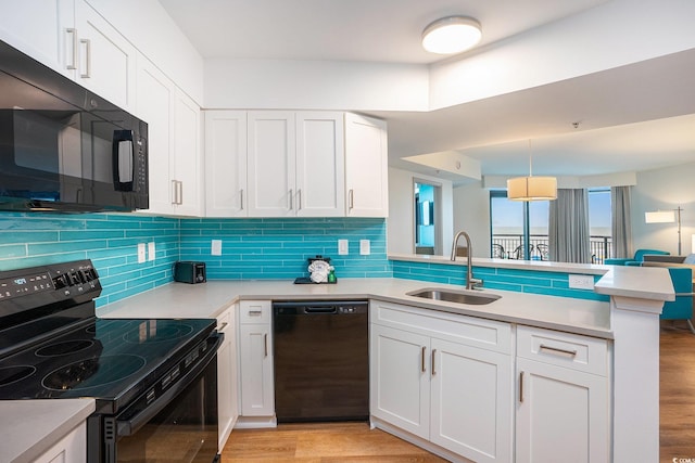 3000 N Ocean Blvd Unit 209, Myrtle Beach, SC 29577 - kitchen featuring black appliances, a peninsula, light countertops, and light wood-style floors