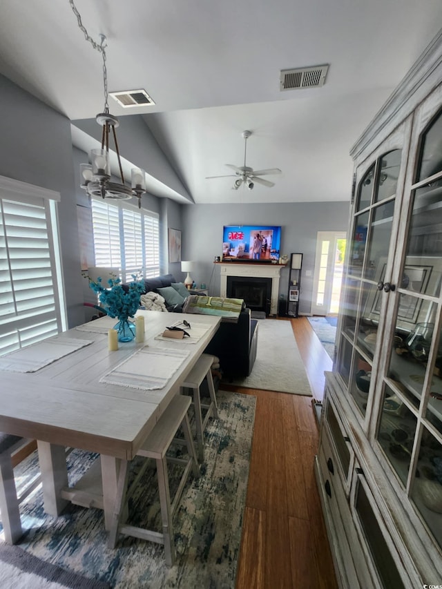 503 20th Ave N Unit 3B, North Myrtle Beach, SC 29582 - dining room featuring vaulted ceiling, plenty of natural light, dark wood-style flooring, ceiling fan, and a fireplace