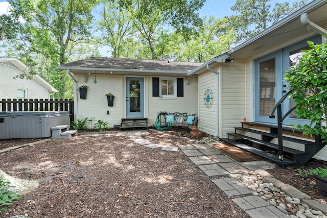520 13th Ave N, Surfside Beach, SC 29575 - rear view of property with entry steps, a hot tub, brick siding, and a shingled roof