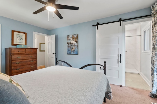 520 13th Ave N, Surfside Beach, SC 29575 - bedroom with a barn door, light colored carpet, ceiling fan, and connected bathroom