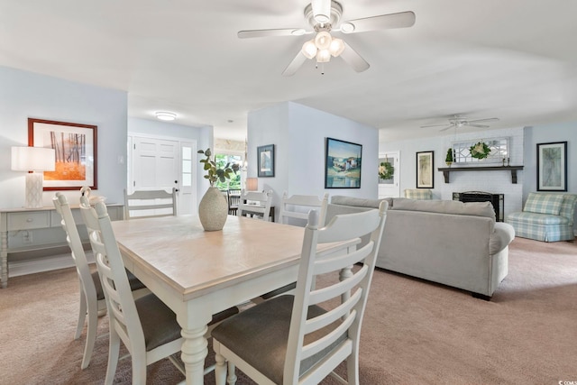 520 13th Ave N, Surfside Beach, SC 29575 - dining area featuring light colored carpet, ceiling fan, and a fireplace