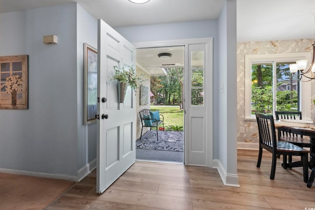 520 13th Ave N, Surfside Beach, SC 29575 - foyer entrance featuring light wood-type flooring and a chandelier