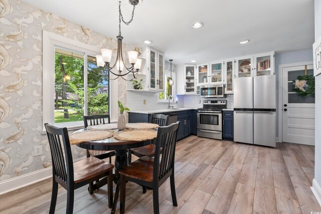 520 13th Ave N, Surfside Beach, SC 29575 - dining space featuring a chandelier, light wood finished floors, recessed lighting, and wallpapered walls