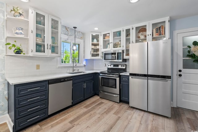 520 13th Ave N, Surfside Beach, SC 29575 - kitchen with stainless steel appliances, light countertops, white cabinetry, light wood-style flooring, and recessed lighting